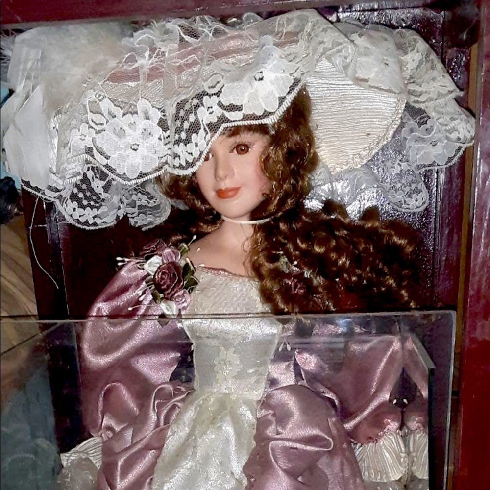 Porcelain Doll, 2 feet tall, size is 22 still as New
